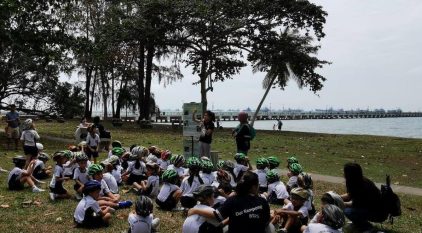 Group of people being briefed by 2 adults