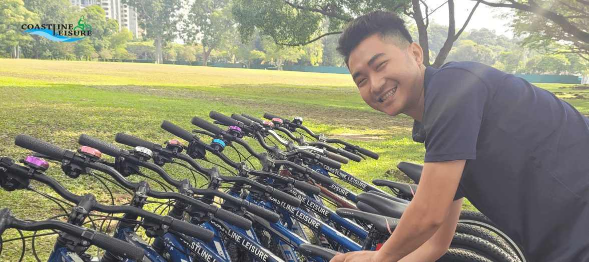 Person posing & smiling while picking out a bicycle