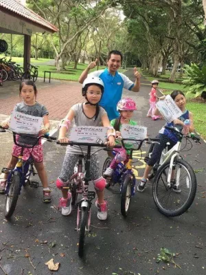 Kids with Coastline leisure coach holding bicycle training certification