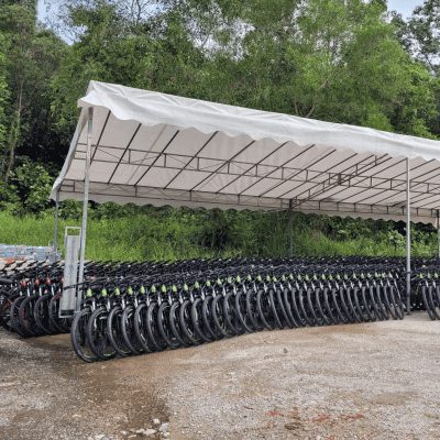 Bicycles lined under a tent/shelter